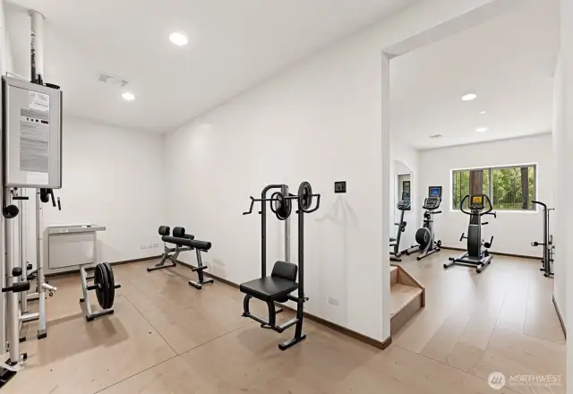 Utility room in basement is versatile for all manner of uses.  Virtually staged here as a home gym.