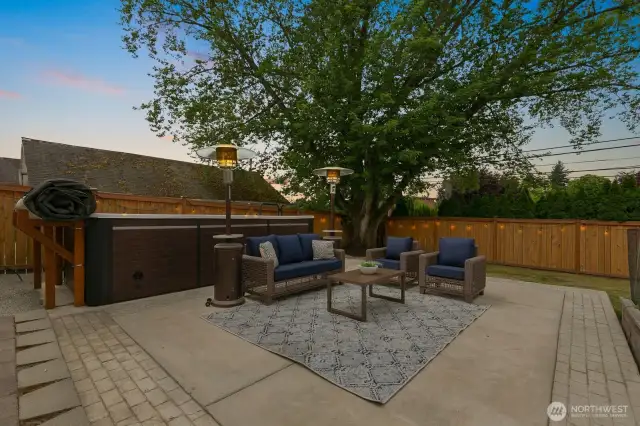 Looking from the patio out to the yard. The swim spa is a favorite, or have your very own firepit (or mini sports court?) right here!