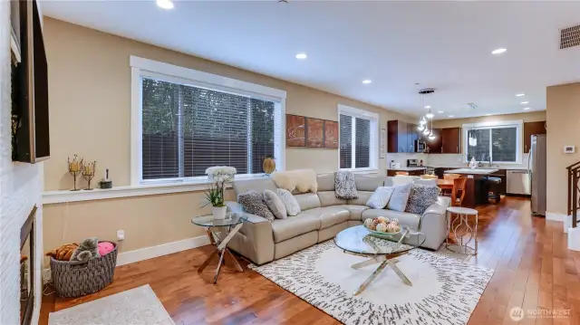 Open & light family room with custom tile, gas fireplace surround, maple hardwood floors throughout.