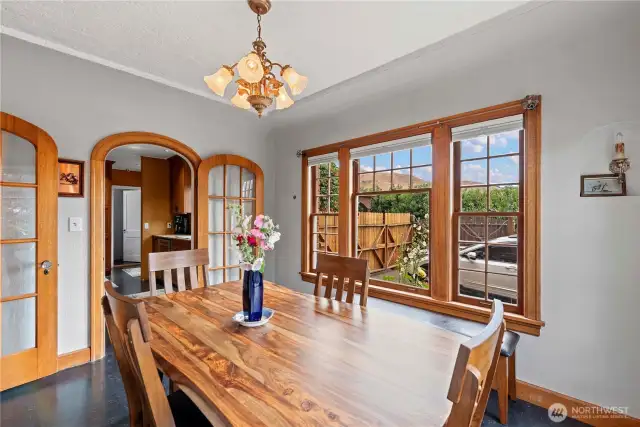 The 1928 Tudor features a formal dining room, with its mahogany wood trim windows and doors. Situated right off the foyer, it is the perfect entertaining space as well as a light flooded morning corner for coffee.