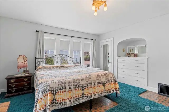 The 1928 Tudor primary bedroom features its fabulous built ins and a separate closet for your goods and clothes.