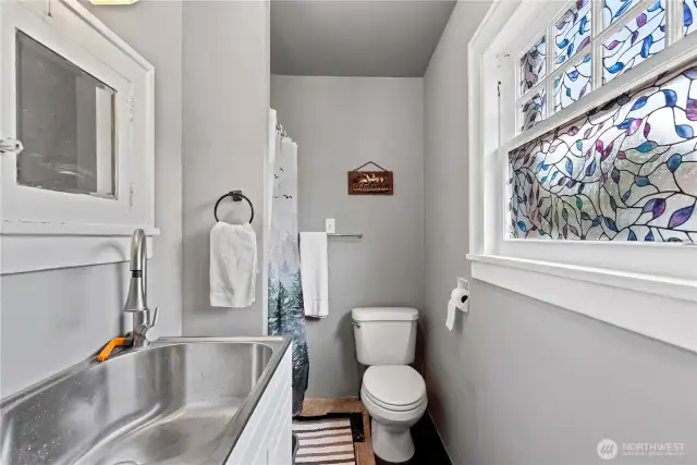 Crisp and cute .75 bath, on the main floor of the 1928 Tudor.