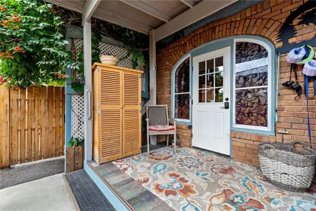 The kitchen porch on the 1928 Tudor is perfect for every day access to the home from the garage, and a fabulous corner to sit and watch the hummingbirds in the flowers that shade it.