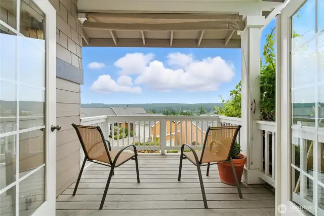 Perched at the top of the hill, the deck off the kitchen offers a peaceful backdrop of trees, rooftops, and open skies—perfect for relaxing or entertaining.