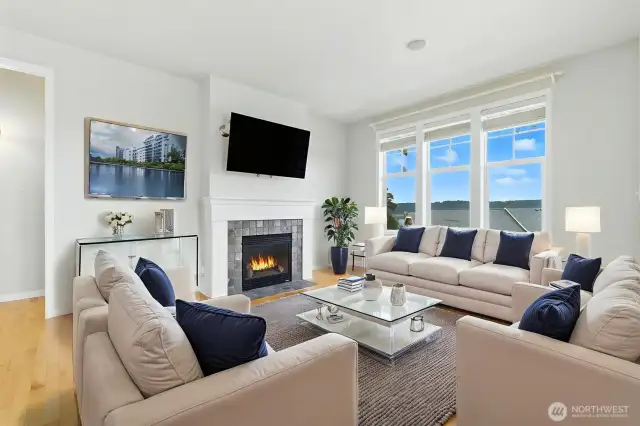 Bright and welcoming, the casual living space features large view windows and an open-concept layout that flows seamlessly into the kitchen.