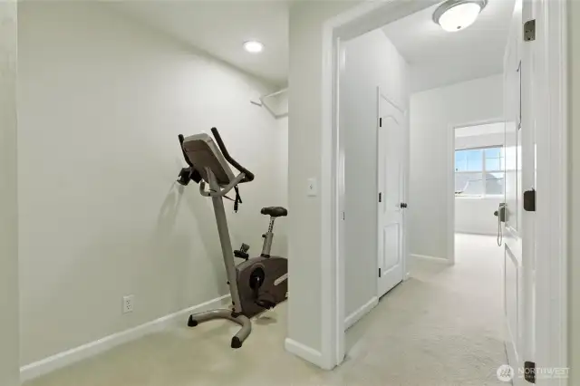 A cozy nook on the lower level is currently set up with a cycle machine but could easily be transformed into a small library, reading corner, or creative workspace.