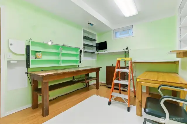 The lower-level office or workshop offers a quiet, dedicated space that could easily be converted into a podcasting room, creative studio, or any focused work area you need.