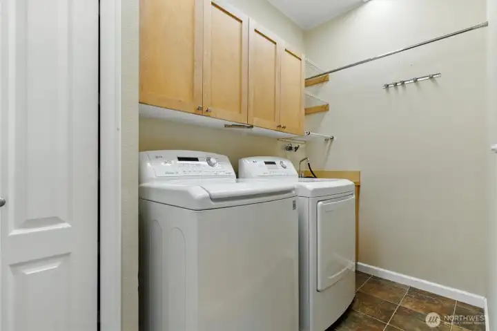 The dedicated laundry room is both functional and organized, featuring built-in cabinets for plenty of storage and a clean, efficient space for daily tasks.