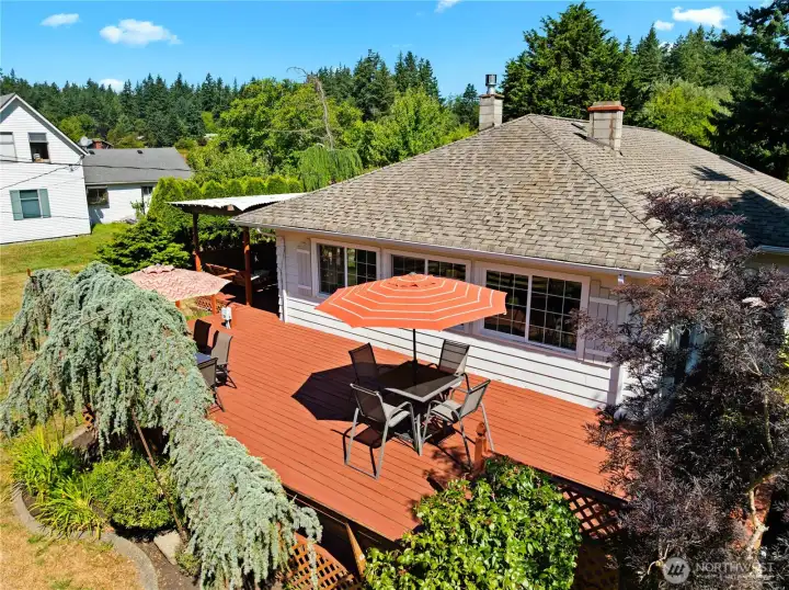The decks surround three sides of this charming house, with bench seating on many sides.