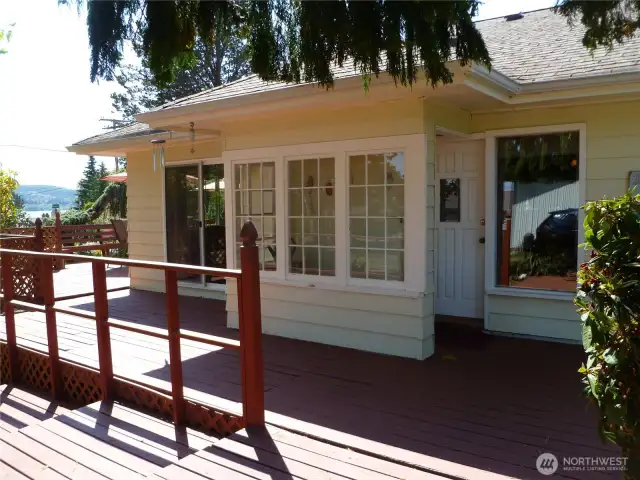 Covered front porch has open-air mud-room, sun-room, potting area.  You can see the Channel to the left.
