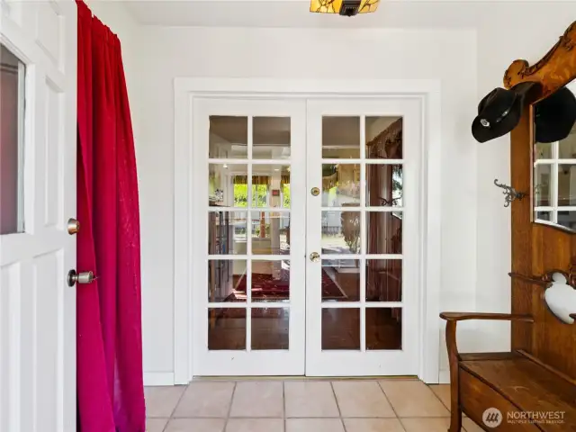 Entry vestibule with closet and French doors to rest of home.