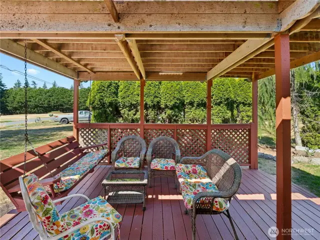 Covered patio connects to front deck and house.