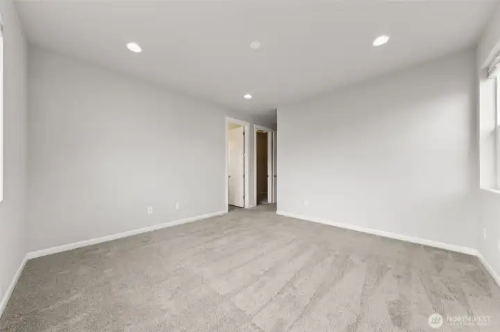 Primary suite - attached 3/4 bathroom, XL walk-in closet & recessed lighting.