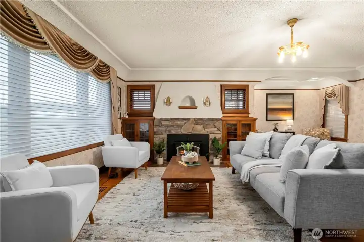 Main living space off the entry w/grand fireplace surrounded by custom built-ins