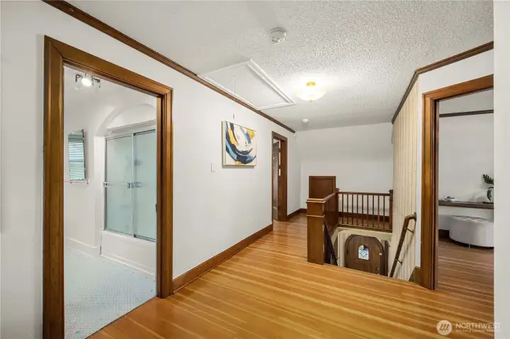 In the ceiling to the left of the stairs is your finished attic access