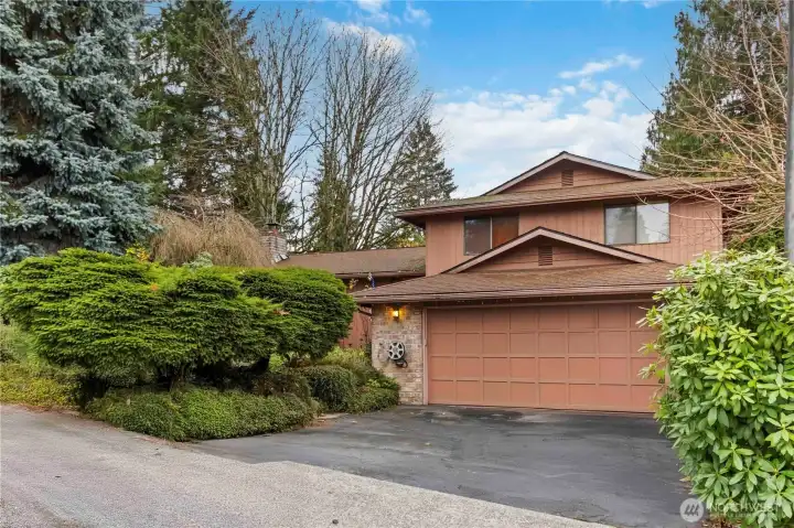 Charming tri-level home with lush landscaping and a spacious two-car garage