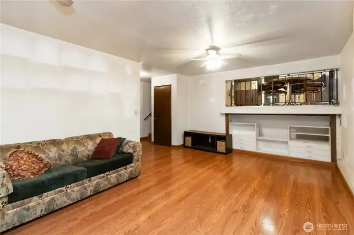 Spacious lower-level family room with warm flooring—perfect for movie nights or a cozy hangout
