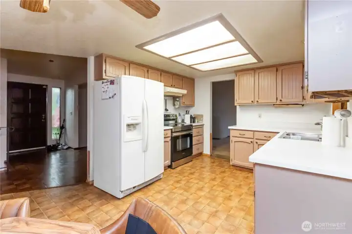 Spacious kitchen area with eating space offering tons of storage and natural light