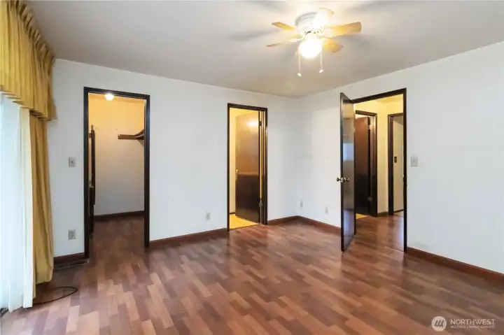 Spacious primary bedroom with private deck access, walk-in closet, and en-suite bath