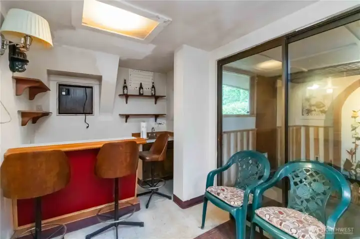 Compact bar area with shelving and seating, offering endless creative potential