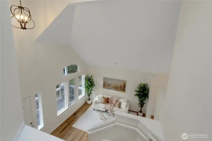 Soaring ceilings are the first thing you notice upon entering the home. This is a view from upstairs looking down over the formal living room.