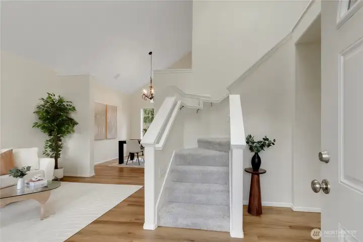 Entry way with a winding stairway to the 2nd level, formal living and dining rooms to the left and a spacious office/ den to the right. Home has all new interior paint and is so clean and fresh! All new flooring through includes  LVP flooring, Plush stain master carpet and beautiful porcelain tiles.