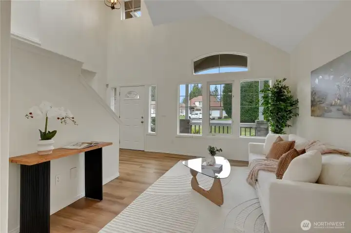 Another angle of the living room looking out the large windows to the covered porch