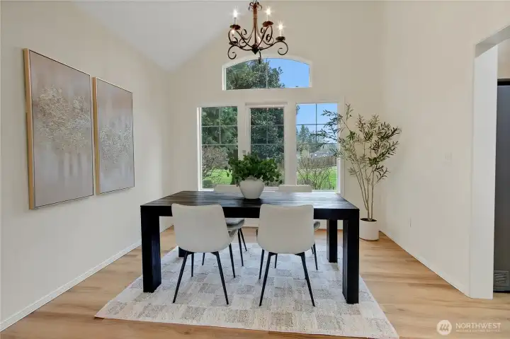 Formal dining room with beautiful windows that look out to the spacious backyard.