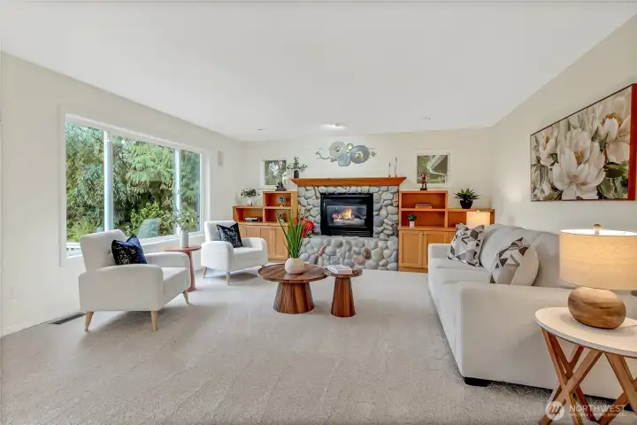 Family room off the kitchen is so inviting with its large windows for a ton of natural light that overlooks the back patio. Gas fireplace with bookshelves and mantle adds the perfect balance.