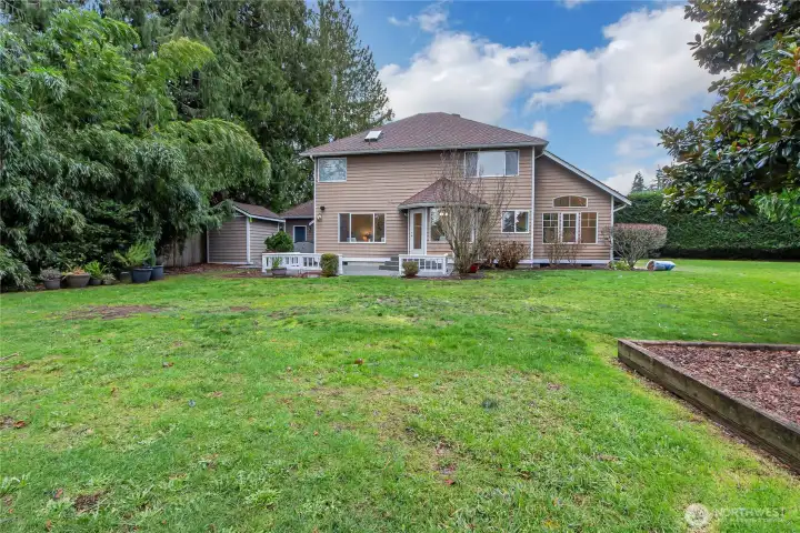 Another shot of the backyard. There is a large raised garden bed to the right in this picture.
