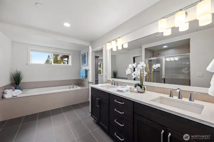 Primary bath features large soaking tub, walk-in shower, dual vanities and walk-in closet.