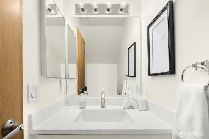 Downstairs powder room with updated quartz countertop.