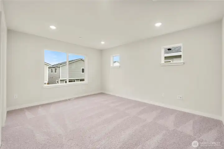 Primary Bedroom. Photos of a previously completed home. Actual colors and finishes may vary. See site agent for details.