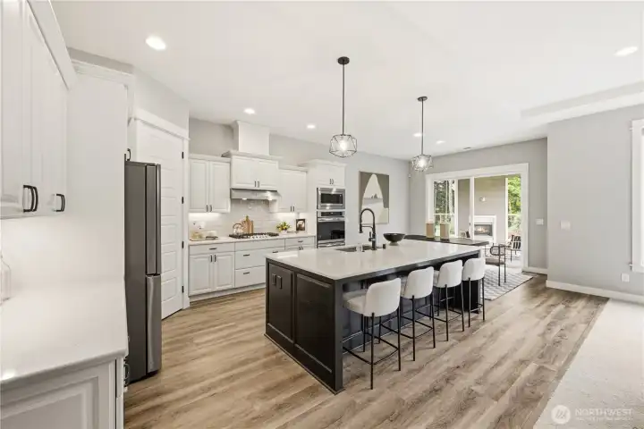 Chef's kitchen features an expansive island