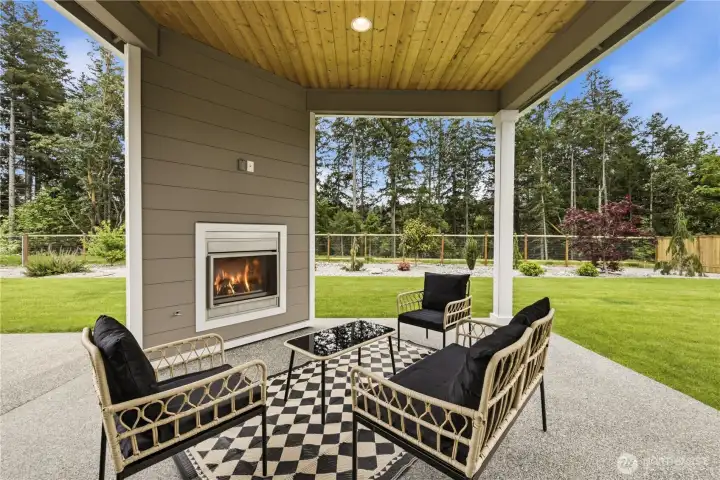 Outdoor fireplace overlooking your beautifully landscaped and fully fenced backyard.