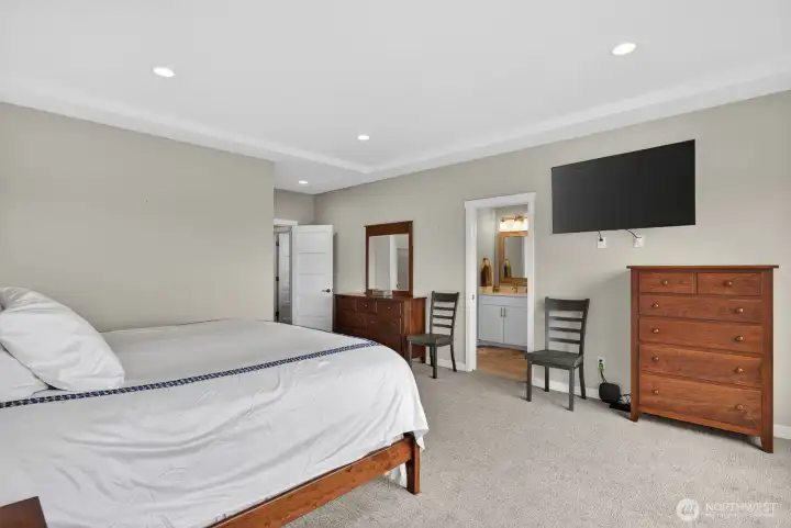 The generously sized primary suite is a true retreat, featuring stunning views, private deck access, a walk-in closet, and ensuite
