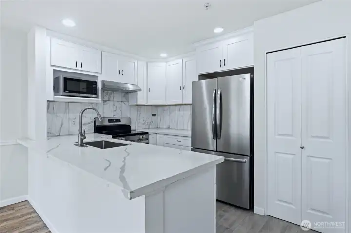 Recently Remodeled Kitchen with Stainless Steel Appliances, Quartz Counters & Tile Backsplash