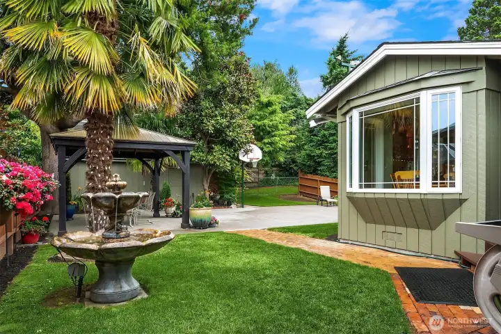 Stepping into the back yard reveals a resort-style oasis anchored by a soothing water fountain. Stepping into the back yard reveals a resort-style oasis anchored by a soothing water fountain.