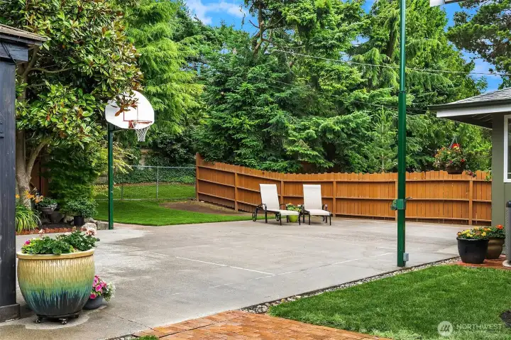 Basketball hoop, sport court, and gate showing towards the easement. Basketball hoop, sport court, and gate showing towards the easement.