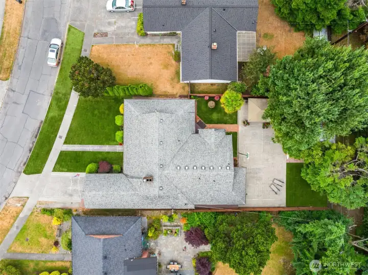 Overhead shot of the property with sport court on the right and the detached garage under the tree. Additional parking inside the gate to the right. Overhead shot of the property with sport court on the right and the detached garage under the tree. Additional parking inside the gate to the right.