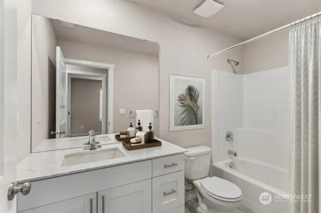 Secondary bathroom features bathtub. Huge island! Pictures are for example only.