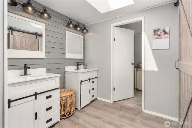 Primary bathroom with double sinks, walk-in closet, sky light, a separate bath & shower & toilet.