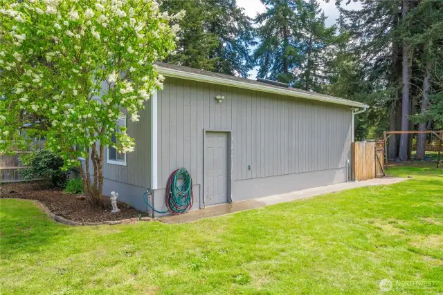 Side entrance to the 832 sqft garage with a shop