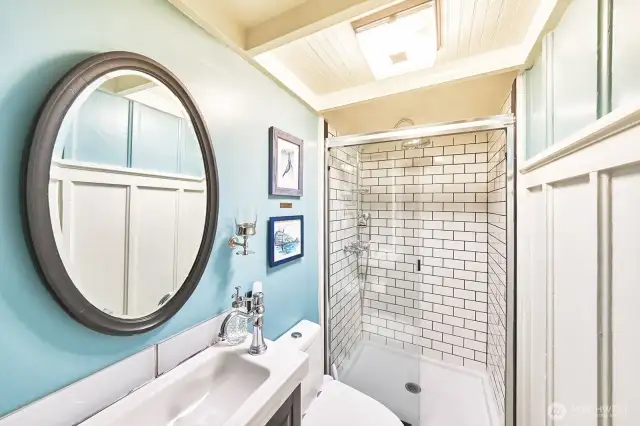 Remodeled bathroom with tiled shower and cool double door