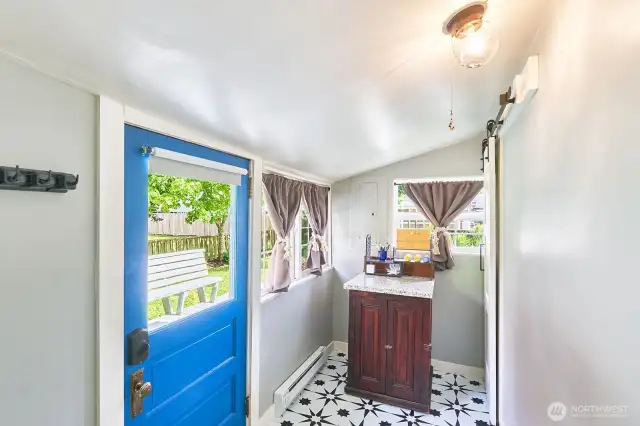 Back door of mudroom o deck. Hot water heater behind barn door.