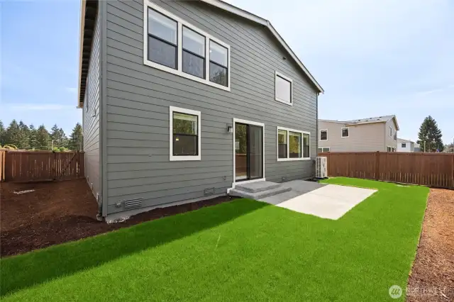 Back yard includes full fencing, showing another home for sale in community.