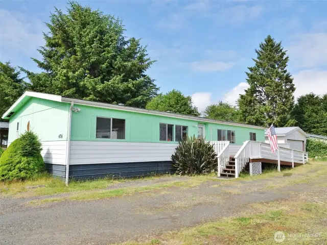 Front view of this doublewide manufactured home and 2-car detached garage.