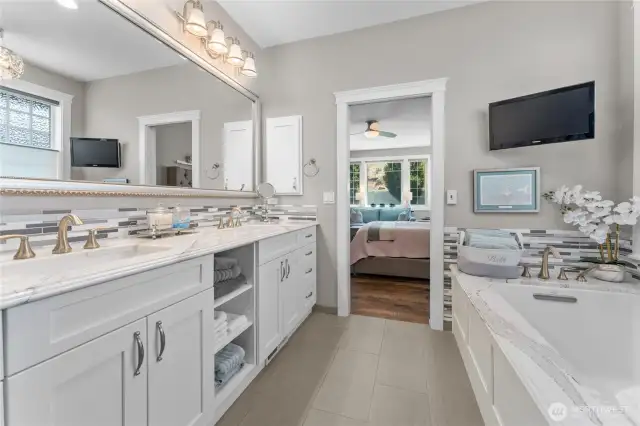 Primary ensuite bathroom with radiant heated floors, epoxy grouted tile, quartz countertops.