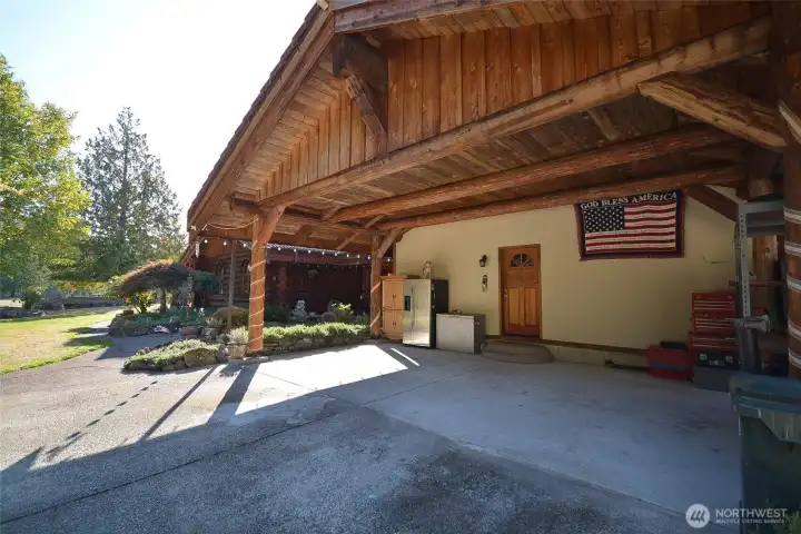 An enormous covered carport (approximatley 400 sq ft) has a concrete tile roof, same as the home. I is also finished with log system and ship lap boards for the ceiling. The structure is supported by massive logs. and built on a concrete slab. It is large enough to house at least four vehicle under cover. Above the carport is a sizeable area of built in storage space. There is about 390 sq ft of storage and it is accessed from the outside.