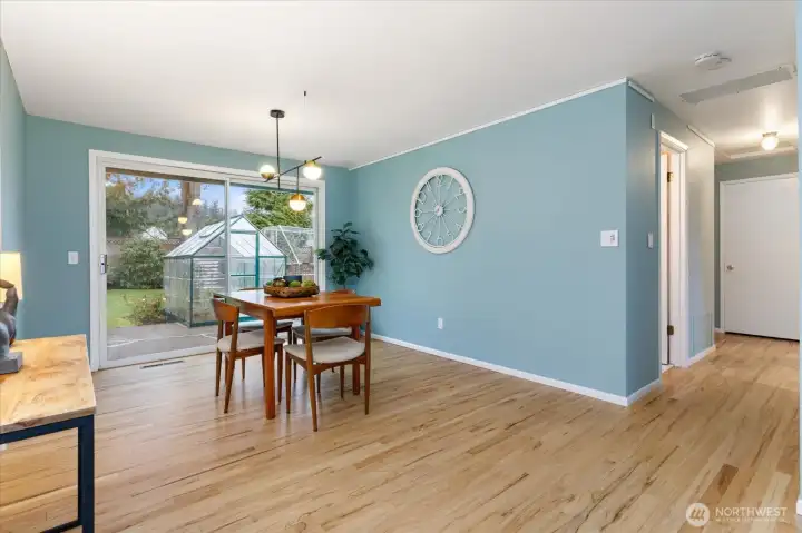 A spacious dining room with access to the back yard.